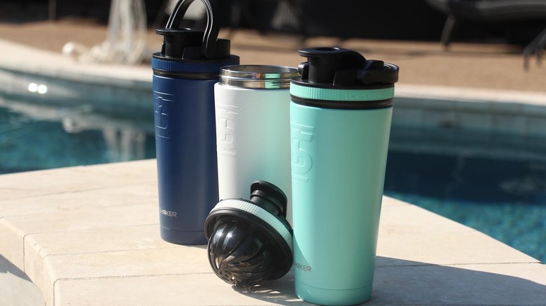 Three Ice Shaker bottles by a pool