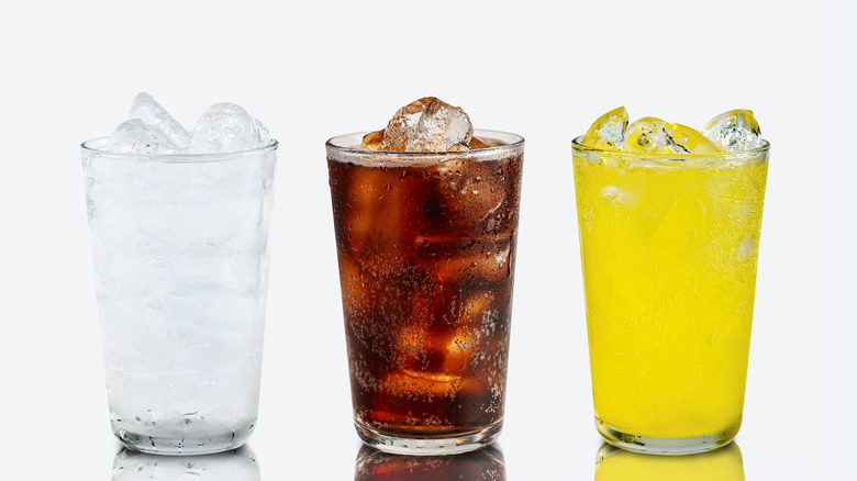 Different soft drinks in iced glasses