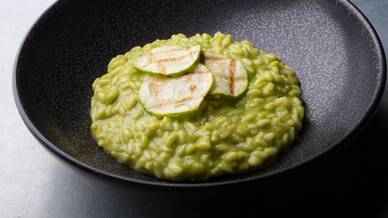 Zucchini risotto on black plate