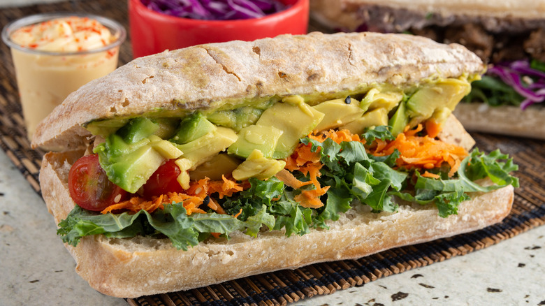 Sandwich bread with kale salad, carrots, avocado