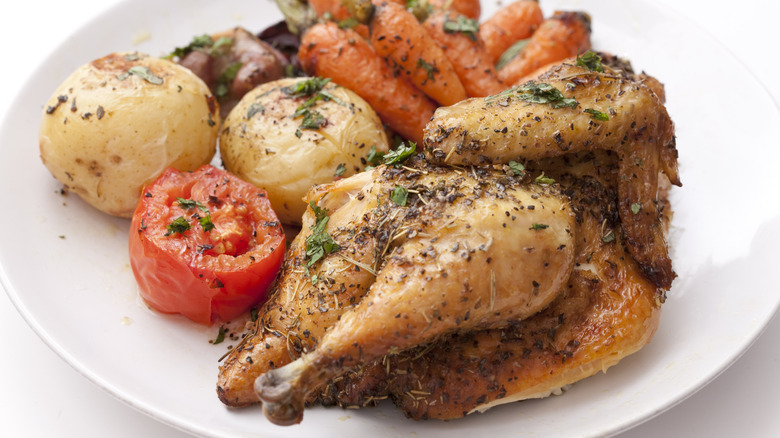 Roasted chicken with carrots, tomato, and potatoes