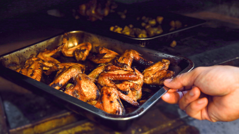 tray of wings coming out of an oven