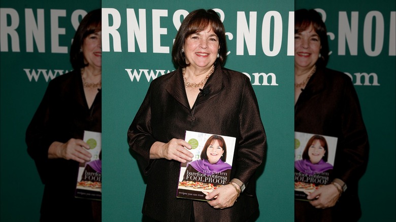Ina Garten poses with one of her cookbooks