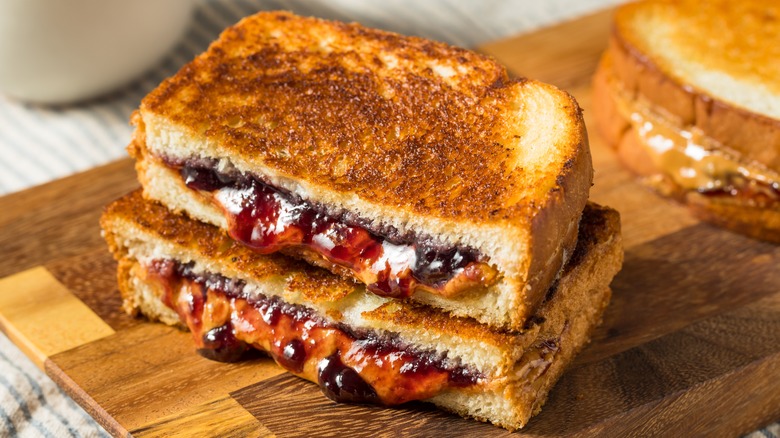 Toasted peanut butter and jelly sandwich sliced in half