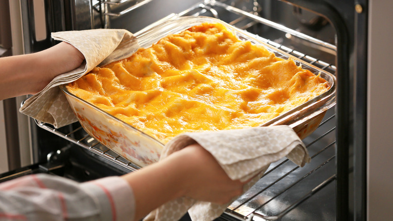 Lasagna dish coming out of oven