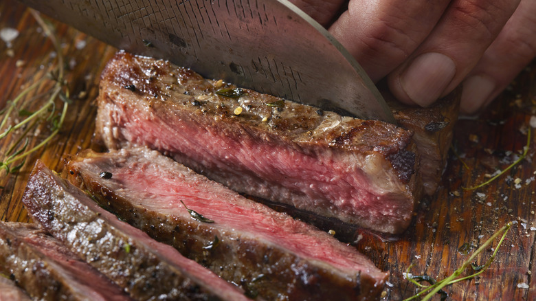 Slicing into medium rare steak