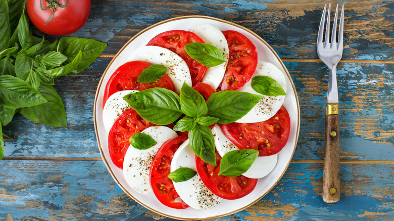 Italian caprese salad of tomatoes, mozzarella cheese, basil