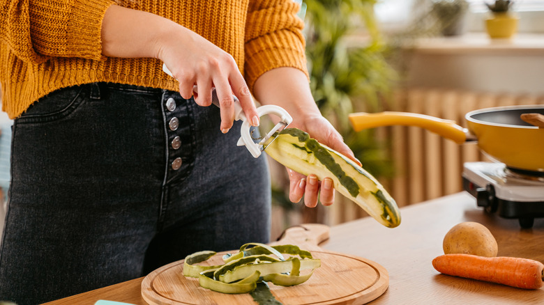 woman peeling zucchini