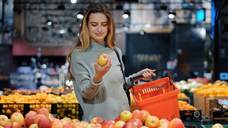 Shopper holding an apple