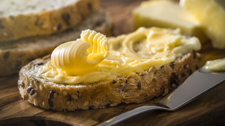 yellow butter spread on slice of bread