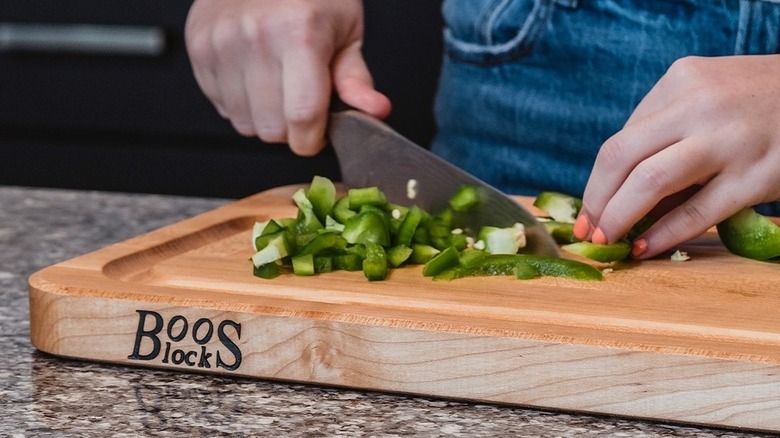 chopping peppers on maple cutting board