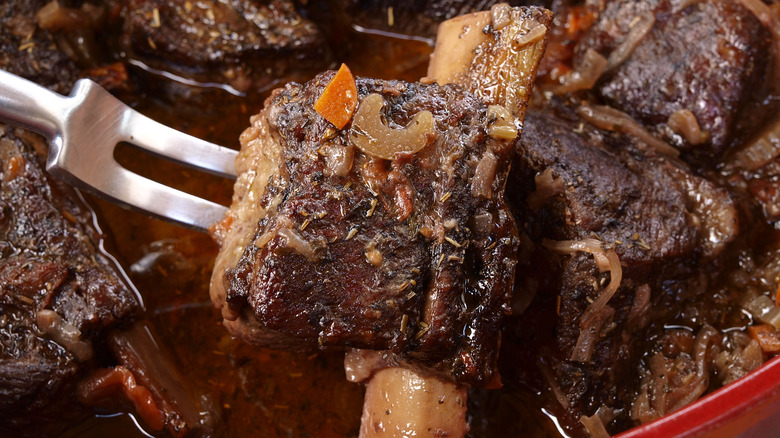 Beef short ribs braising in red wine