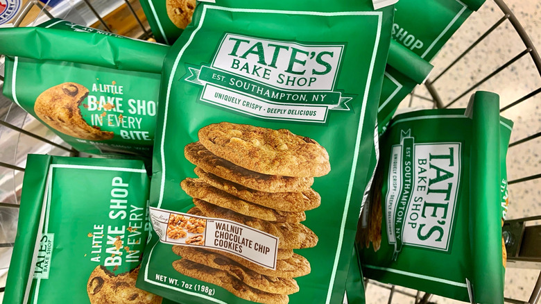 Several bags of Tate's Bake Shop walnut chocolate chip cookies sit in a basket