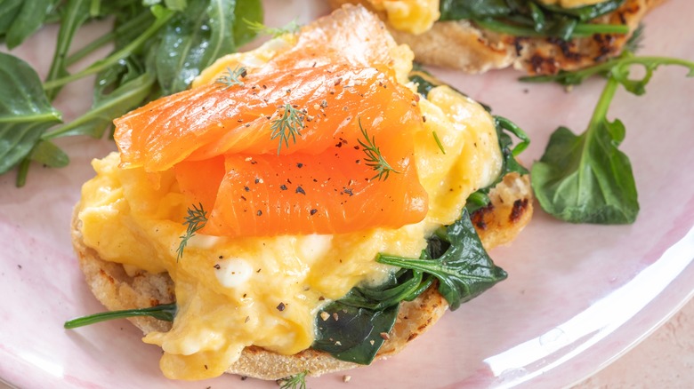 Soft scrambled eggs with smoked salmon and spinach on toast