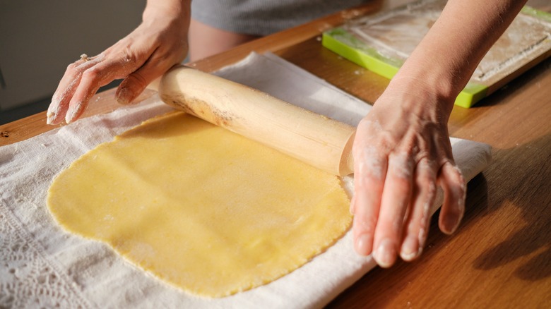 Rolling out dough to make a pie crust