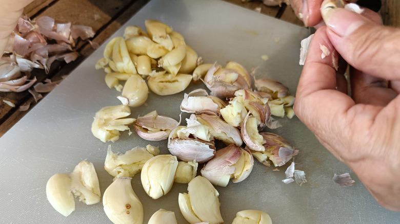 A hand peeling garlic 