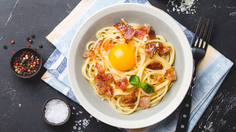 spaghetti carbonara with raw egg yolk on top