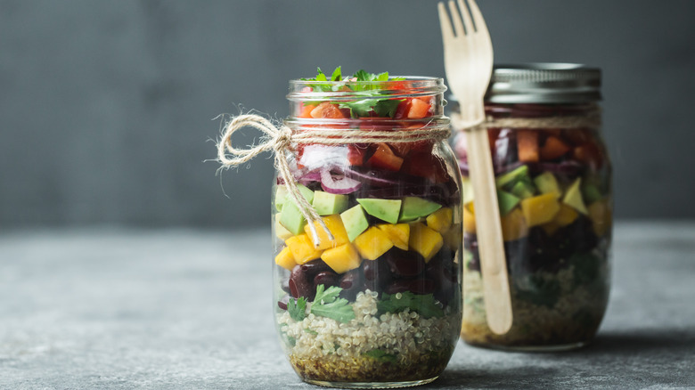 mason jars filled with layered salad