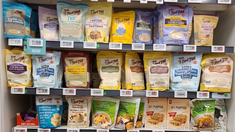 Various gluten-free flours, baking mixes, and other products on a grocery store shelf