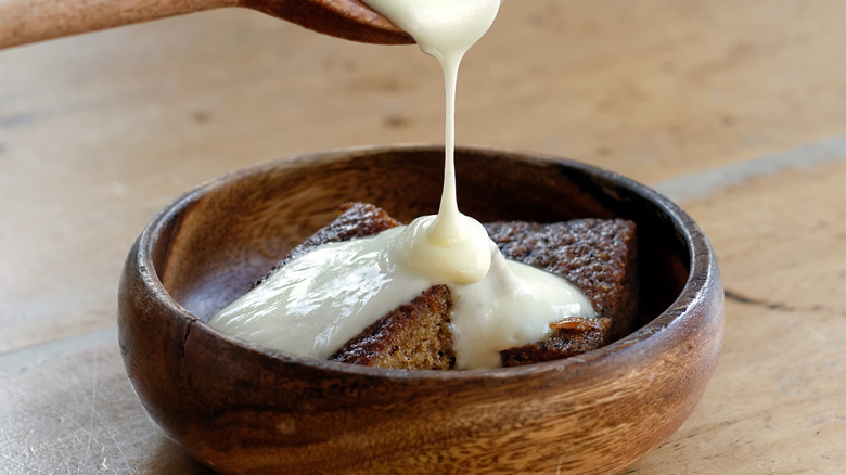 vanilla custard poured on bread pudding