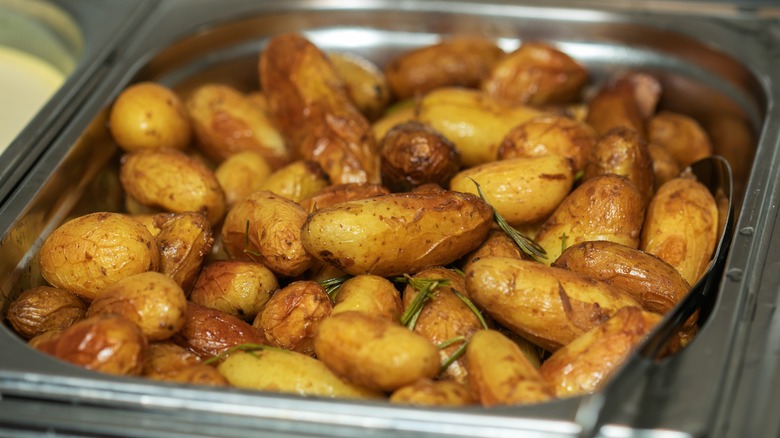 Crispy roast potatoes in pan