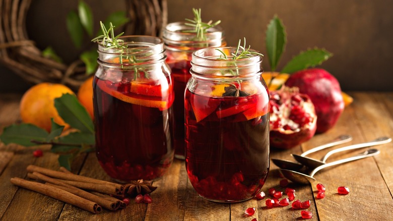 Pomegranate sangria cocktails with fruit in glass mason jars