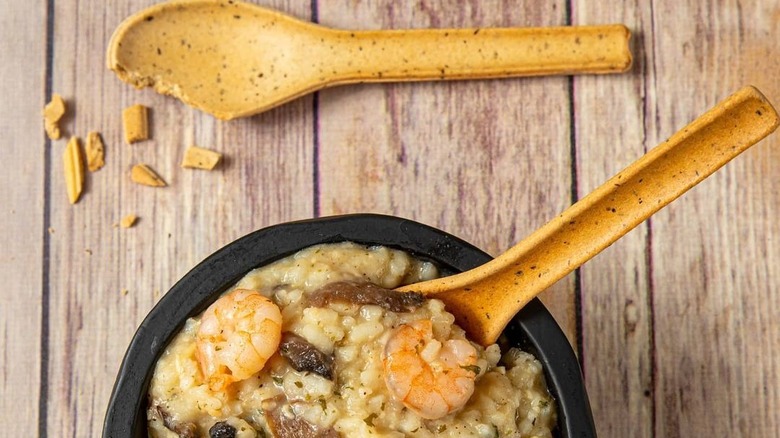 A bowl of risotto with an edible spoon