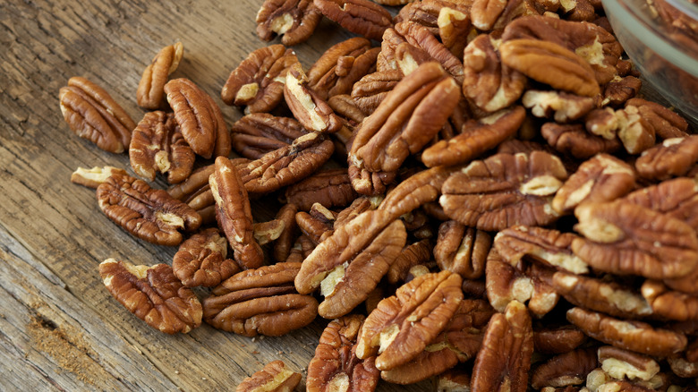 pile of pecans on wooden surface