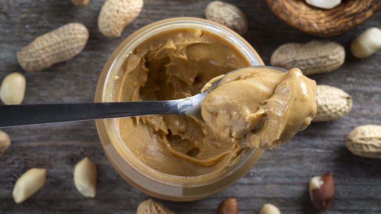 top view of spoonful of peanut butter scooped from jar