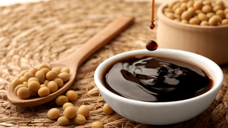 soy sauce surrounded by soy beans