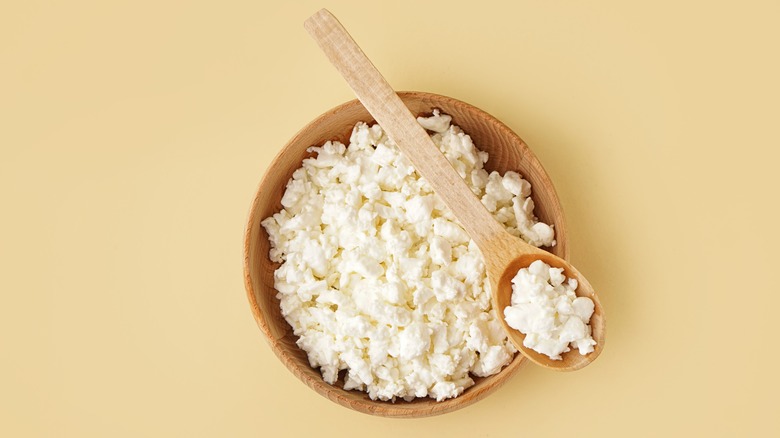 Cottage cheese in wooden bowl 