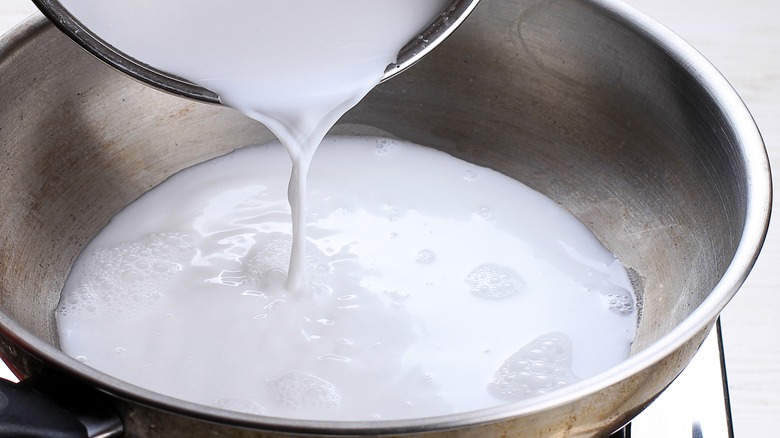 Poring milk into pan