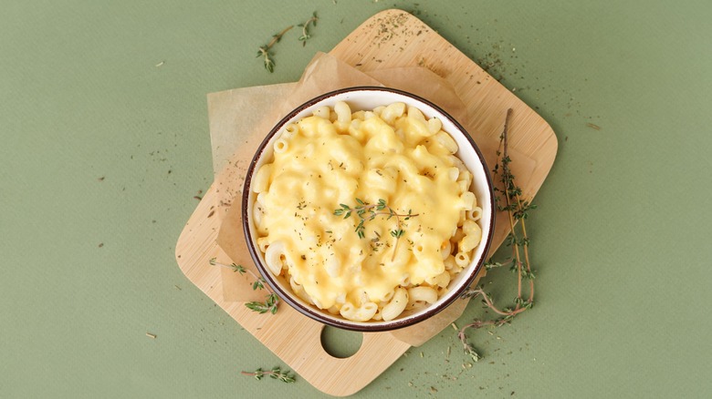 bowl of Mac and cheese on cutting board