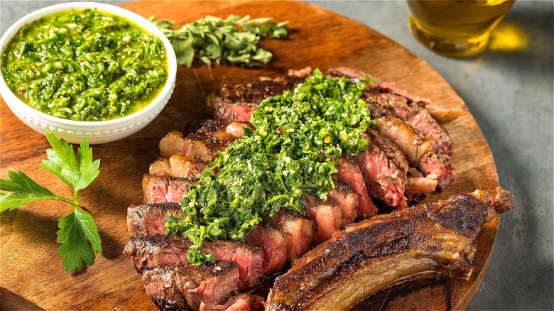 Sliced steak covered in chimichurri sauce