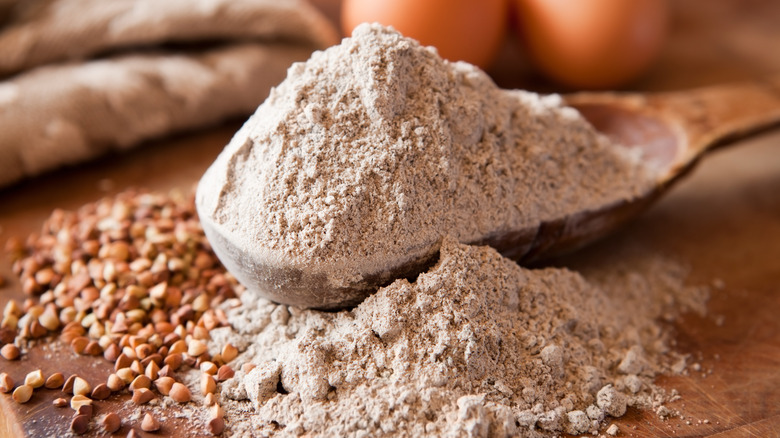 Buckwheat flour in large wooden spoon