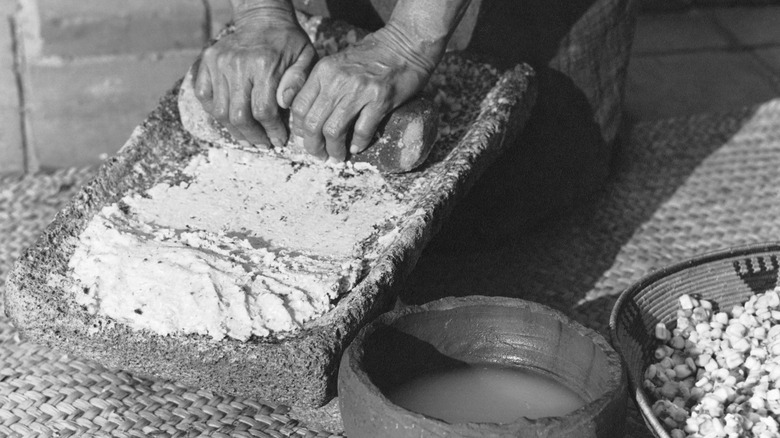 Native Americans grinding cornmeal