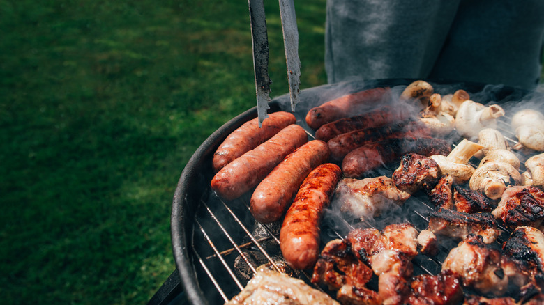 Meat and mushrooms cooking on grill