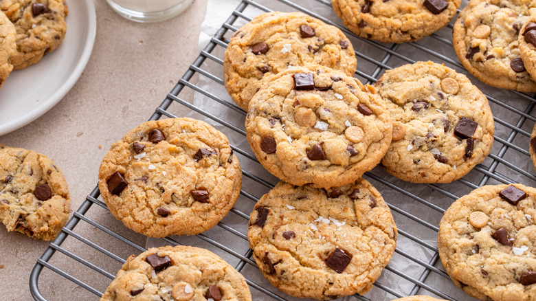 Chocolate chip cookies on a cooling rack with flaky salt