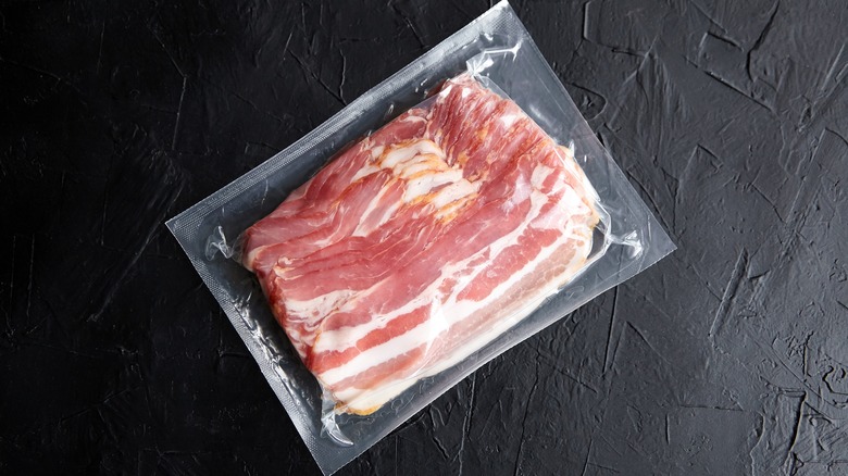 raw bacon sitting on sous vide packaging