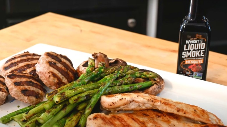 Grilled burgers, asparagus, and chicken with liquid smoke