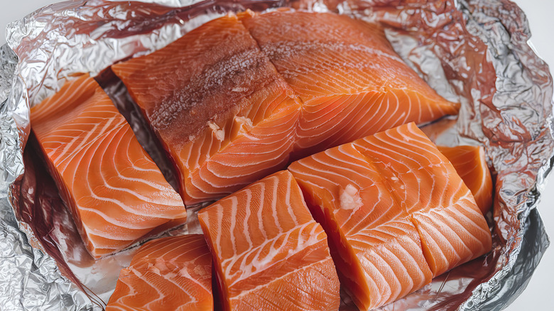 raw salmon portions on foil