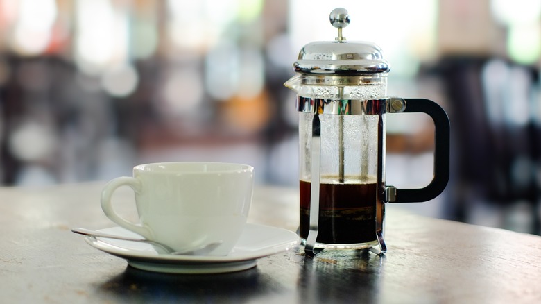 French press coffee with cup