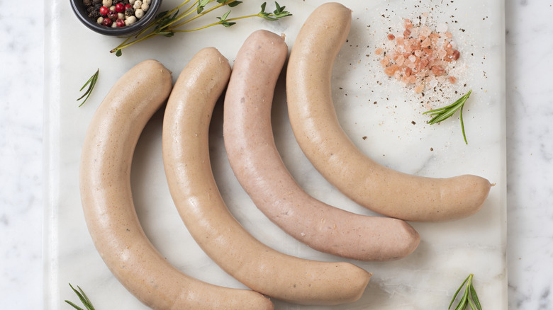 raw turkey sausage links on white background