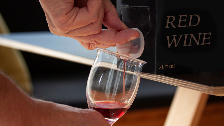 Pouring a glass of red wine from a 3-liter box