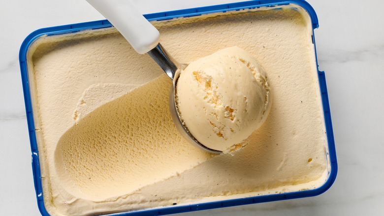 open tub of ice cream and scoop