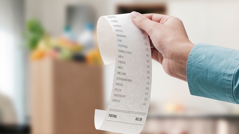 Person holding long receipt