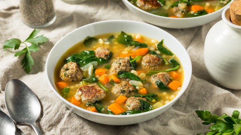 a bowl of Italian wedding soup with spoon