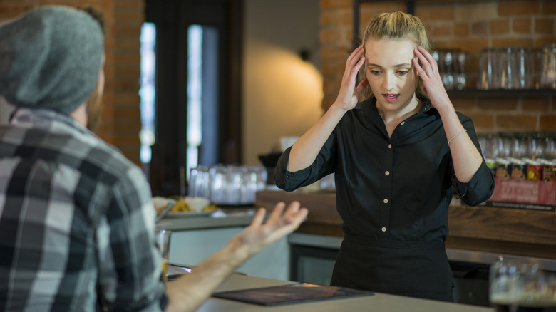 Frustrated server arguing with customer