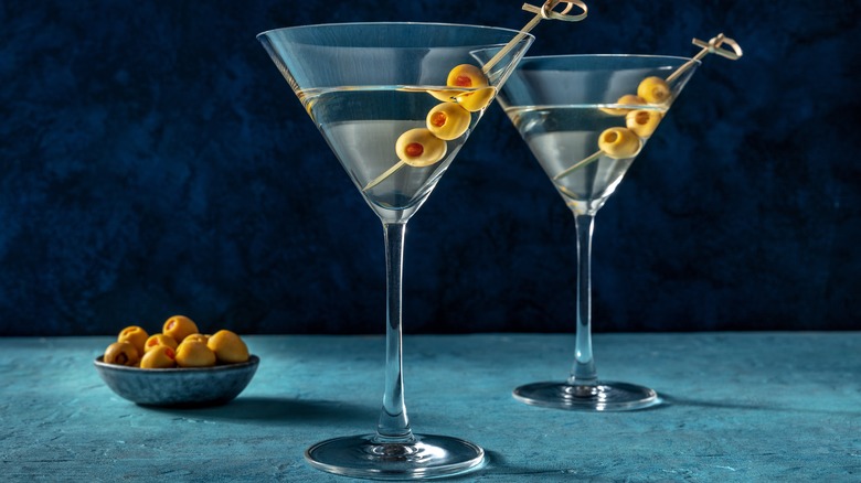Two martinis with bowl of olives