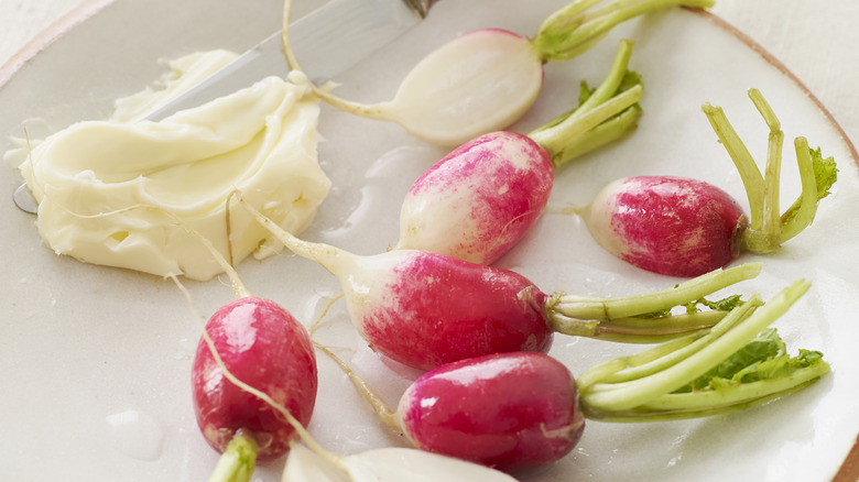 Radishes and butter cutting board